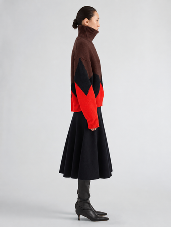 Proenza Schouler Side full length image of model wearing Oren Intarsia Turtleneck in Cashmere Wool in Red Multi