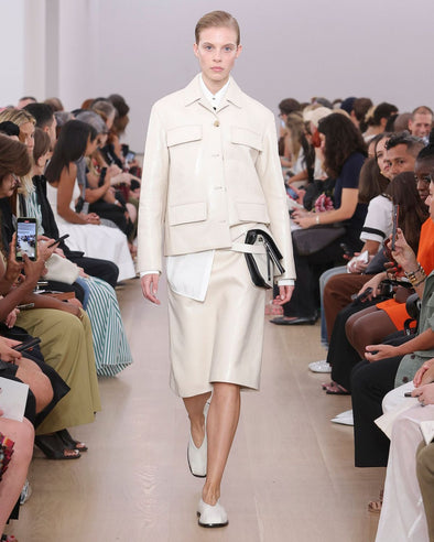 Runway image of model wearing Roos Jacket In Lacquered Leather in ecru