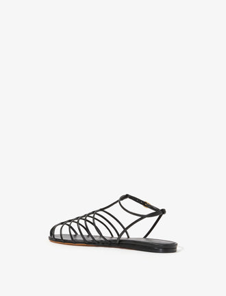 3/4 Back image of Tee Cage Flat Sandals in BLACK