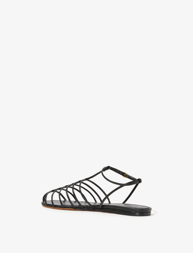 3/4 Back image of Tee Cage Flat Sandals in BLACK