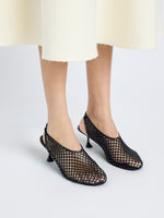Image of model wearing Tee Perforated Slingback Pumps in BLACK