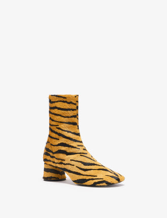 Proenza Schouler front 3/4 image of Glove Ankle Boots in Haircalf in orange/black