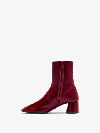 3/4 Back image of Glove Ankle Boots in Slick Nappa in Merlot