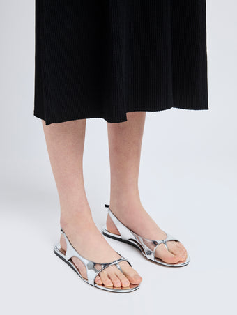 Image of model wearing Slash Flat Thong Sandals in Silver