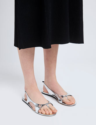 Image of model wearing Slash Flat Thong Sandals in Silver