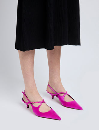Image of model wearing Slash Crossover Slingback Pumps in Fuchsia