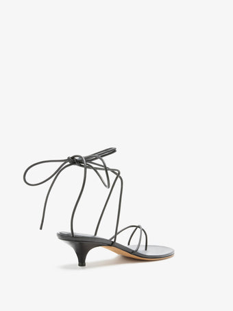 3/4 Back image of Slash Tie Sandals in Black