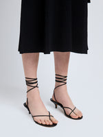 Image of model wearing Slash Tie Sandals in Black