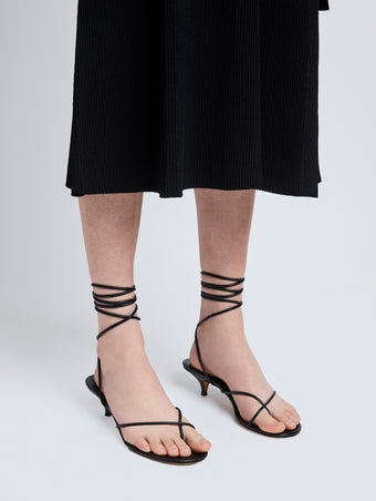 Image of model wearing Slash Tie Sandals in Black
