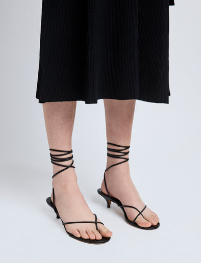 Image of model wearing Slash Tie Sandals in Black