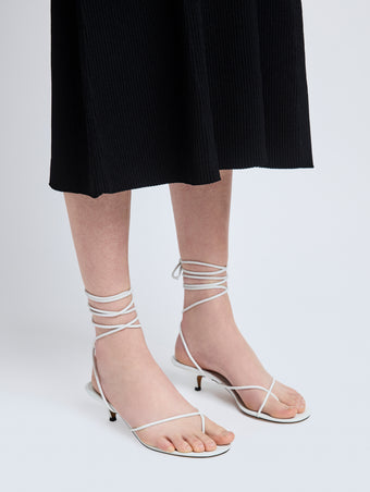 Image of model wearing Slash Tie Sandals in White
