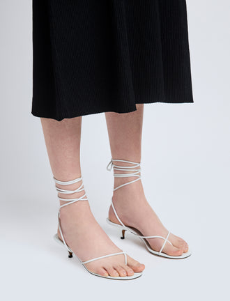 Image of model wearing Slash Tie Sandals in White