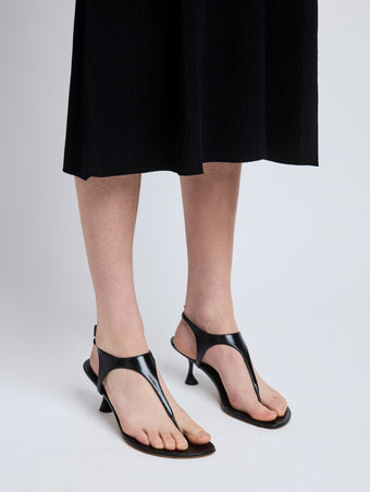 Image of model wearing Tee Thong Sandals in Black