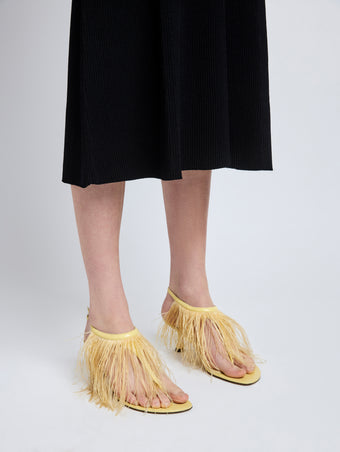 Image of model wearing Tee Thong Feather Sandals in Resin