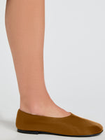 Image of model wearing Glove Slippers in Slick Nappa in Mud
