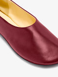 Image of model wearing Glove Slippers in Slick Nappa in Merlot