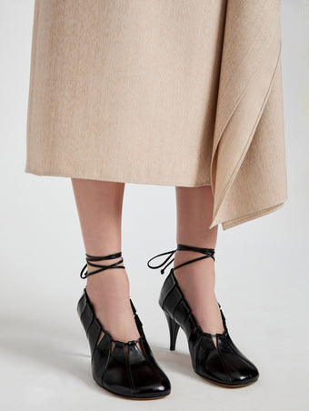 Image of model wearing Glove Hinge Pumps in Black