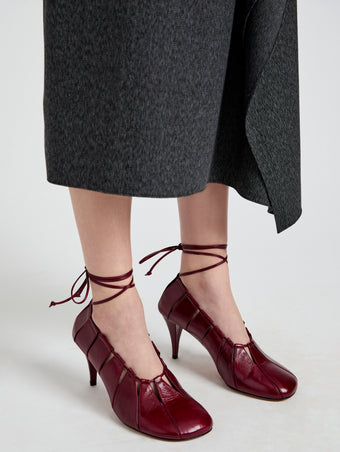 Image of model wearing Glove Hinge Pumps in Merlot