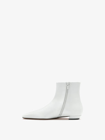 3/4 Back image of Trap Flat Ankle Boots in Spazzolato Leather in Ecru