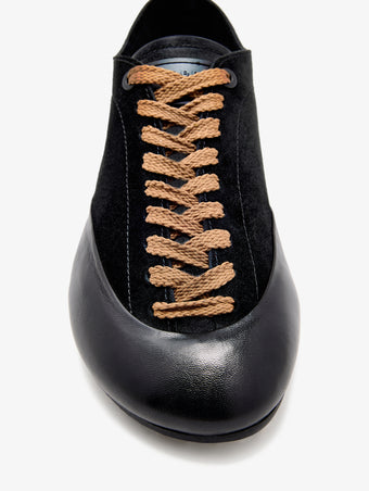 Proenza Schouler aerial image of Arcadia Sneakers in black with tan laces