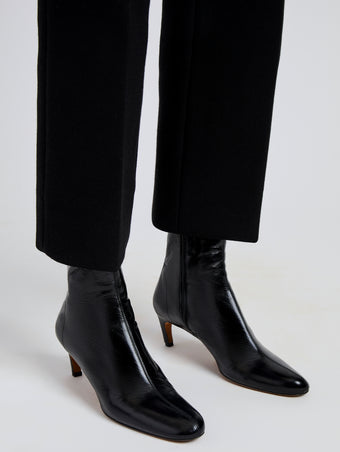 Proenza Schouler Image of model wearing Uma Ankle Boots in Slick Calf in Black