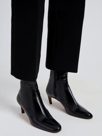 Proenza Schouler Image of model wearing Uma Ankle Boots in Slick Calf in Black