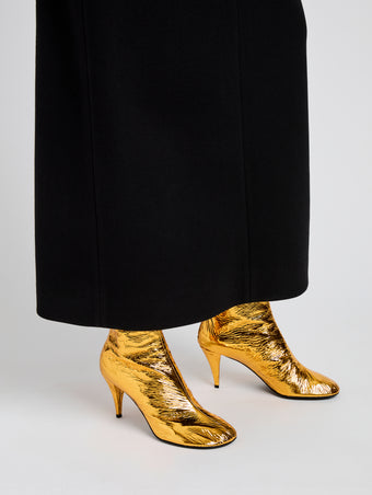 Proenza Schouler Image of model wearing Glove Ankle Boots in Crinkle Gold in Gold