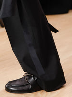 Runway image of model wearing the Monogram Loafer in black