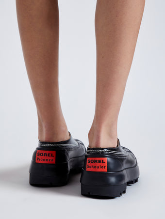 Proenza Schouler image of model wearing SOREL x Proenza Schouler CARIBOU Mule WP in BLACK/CHALK