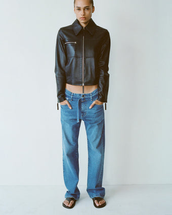 Model wearing Annabel Jacket in Lightweight Leather in black with Ellsworth jean in medium blue