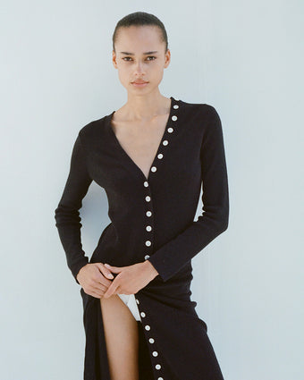Model wearing Cameron Knit Dress in Boucle Viscose in black with button buttons undone
