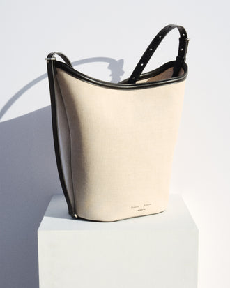 Brant Bucket Bag in Natural Linen in natural/black on white platform