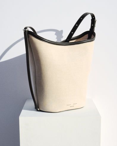 Brant Bucket Bag in Natural Linen in natural/black on white platform