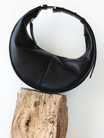 Mini Slide Bag in black on wooden platform
