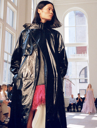 Model walking Proenza Schouler SS25 Runway show wearing Sabina Coat in Lacquered Leather in black
