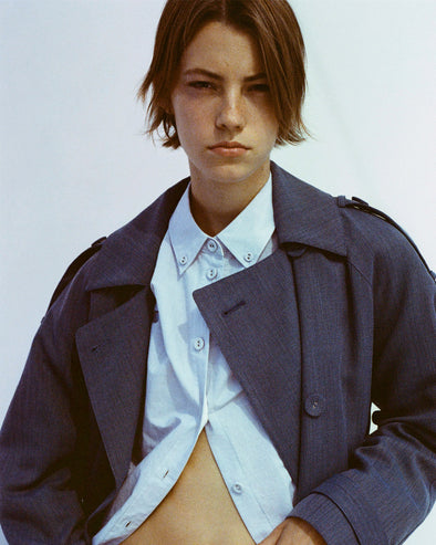 Portrait of model wearing Sakia Coat in Wool Melange in Denim over light blue button up top