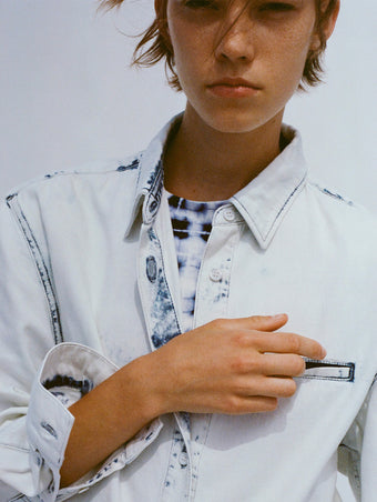 Cropped image of model wearing Kruger Top in bleach out with Parson Tee in Jersey in indigo multi