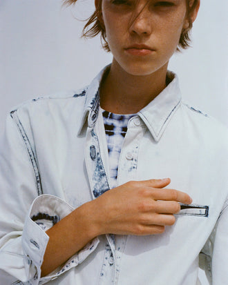 Cropped image of model wearing Kruger Top in bleach out with Parson Tee in Jersey in indigo multi