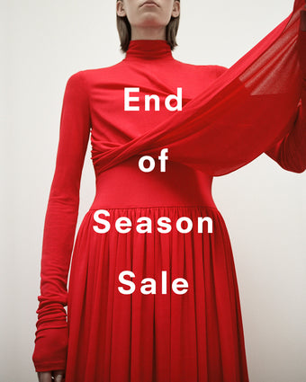 Cropped image of model wearing Meret Dress in Crepe Jersey in red, 'End of Season Sale' overlaid