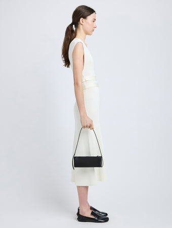 Proenza Schouler image of model carrying Silo Bag in Satin in black