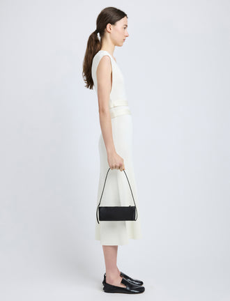 Proenza Schouler image of model carrying Silo Bag in Satin in black