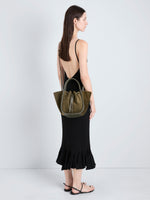 Proenza Schouler Image of model holding Small Ruched Tote in Soft Suede in Olive