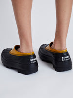 Proenza Schouler image of model wearing SOREL x Proenza Schouler CARIBOU Mule WP in GOLDEN OCHRE/BLACK