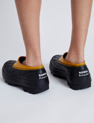 Proenza Schouler image of model wearing SOREL x Proenza Schouler CARIBOU Mule WP in GOLDEN OCHRE/BLACK