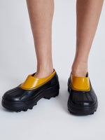 Proenza Schouler image of model wearing SOREL x Proenza Schouler CARIBOU Mule WP in GOLDEN OCHRE/BLACK