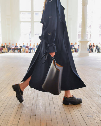 Image of model walking SS25 runway wearing SOREL x Proenza Schouler Caribou mules
