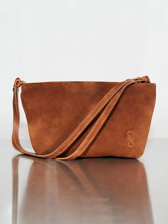 Image of Bond Bag in Suede in saddle sitting on silver backdrop
