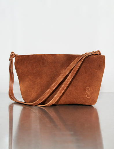 Image of Bond Bag in Suede in saddle sitting on silver backdrop