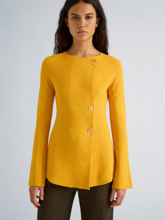 Proenza Schouler Detail image of model wearing Sukki Jacket in Draped Viscose in Marigold