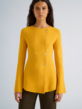 Proenza Schouler Detail image of model wearing Sukki Jacket in Draped Viscose in Marigold